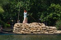 Allepey, Kerala, India Ã¢â¬â March 31, 2015: Indian man transport dwell with rice for boats. backwaters canoe in state Royalty Free Stock Photo